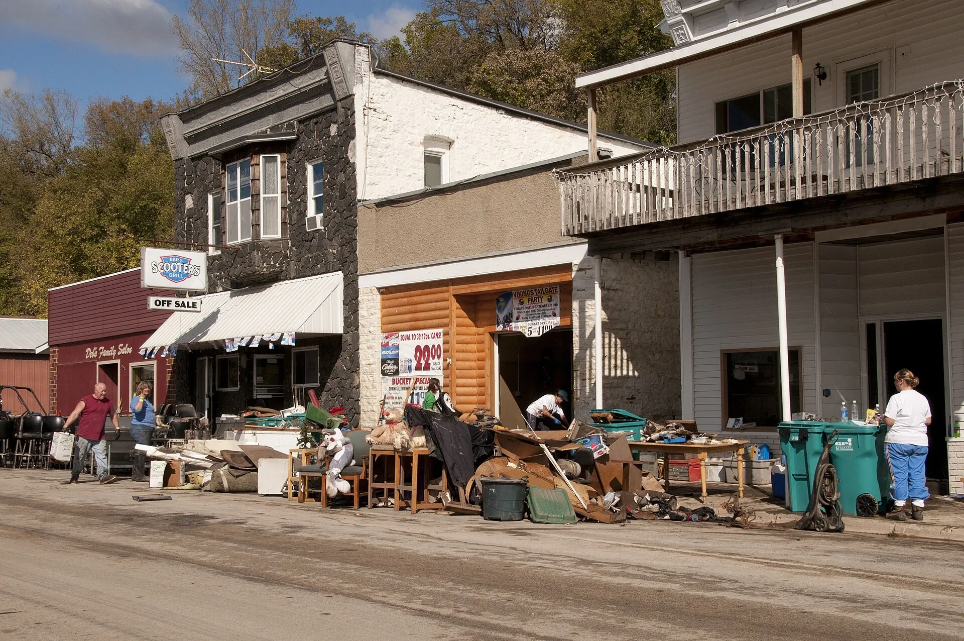 Business owners in Zumbro Falls pile ruined furniture and debris along the main street after the September 2010 flood